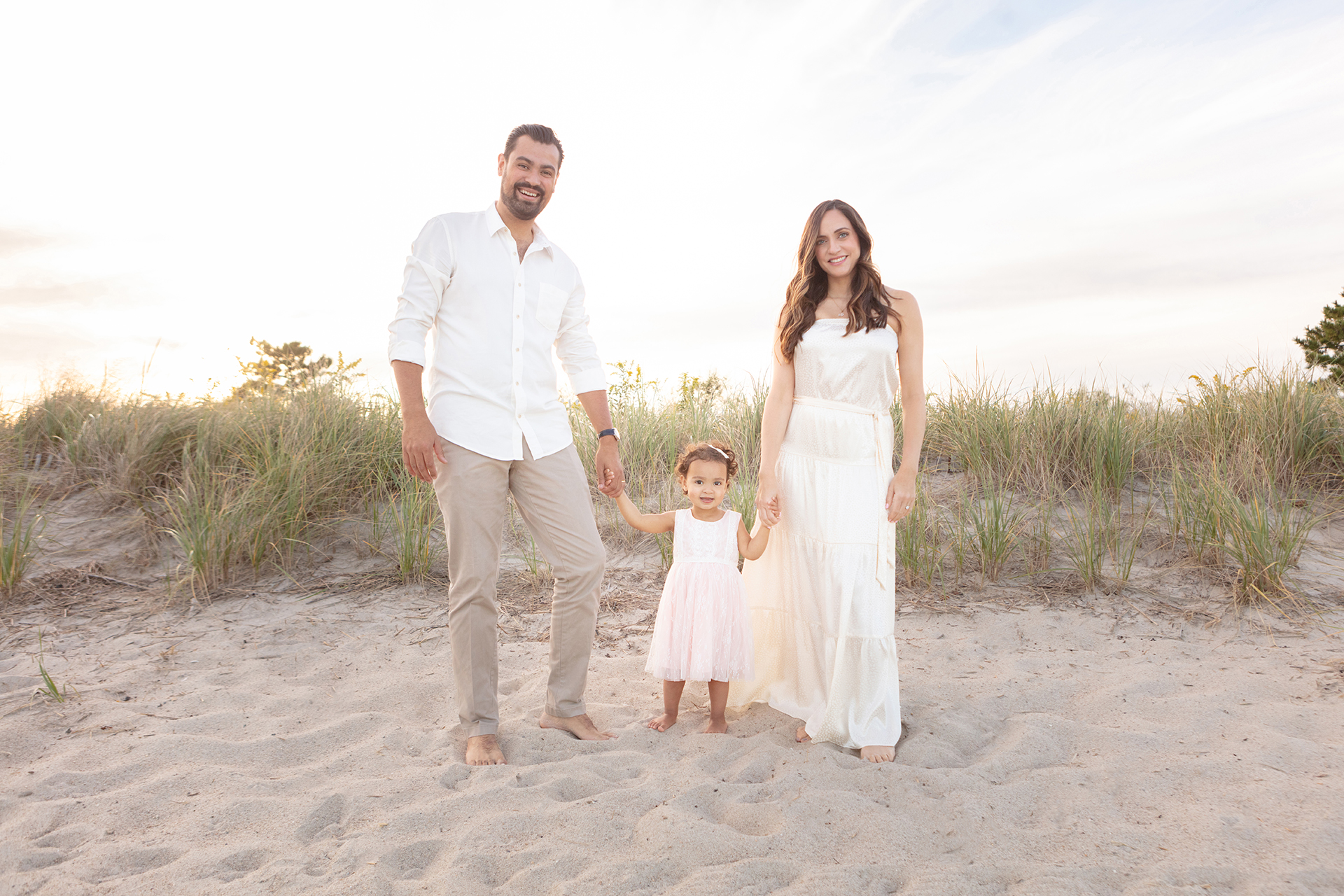 dad, toddler daughter, and mom dressed in neutrals at Tod's Point