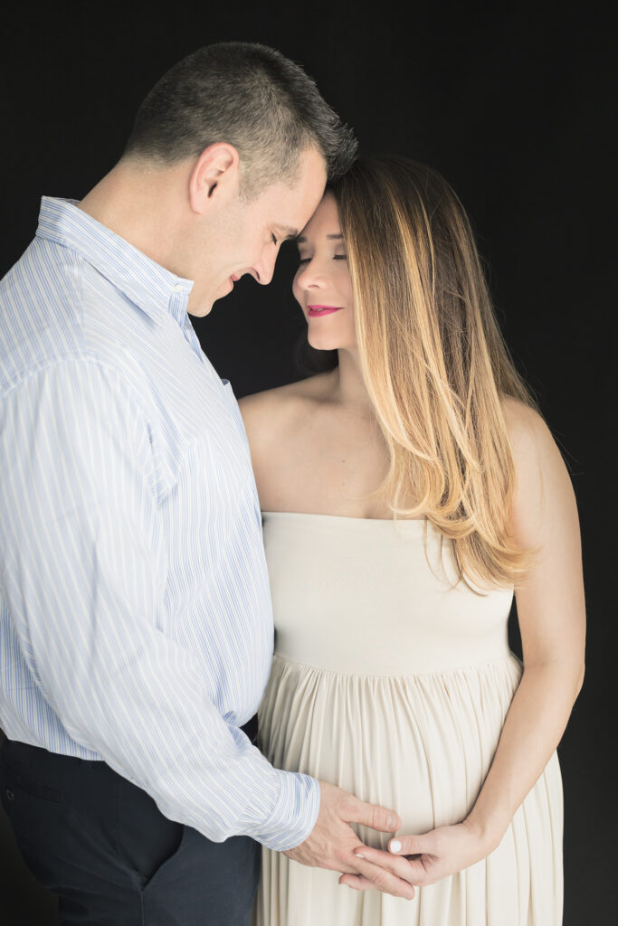 A studio maternity session for a couple is photographed in Greenwich, Connecticut, by Karen Kahn, in her Looking Up Photography studio.