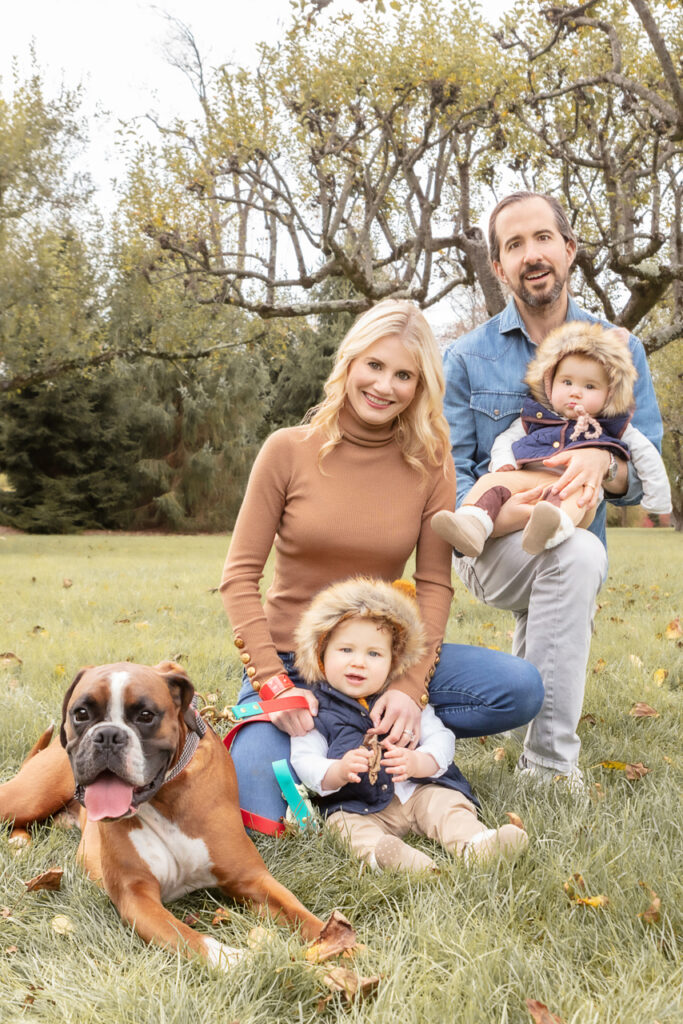Family of four and their adorable dog enjoying the beauty of fall foliage. Embracing autumn's warmth and togetherness.