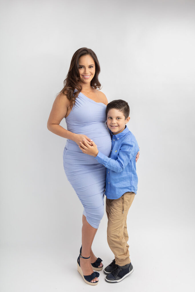 A seven year-old boy and his pregnant mother are photographed in the Looking Up Photography studio in Greenwich, Connecticut, by Karen Kahn