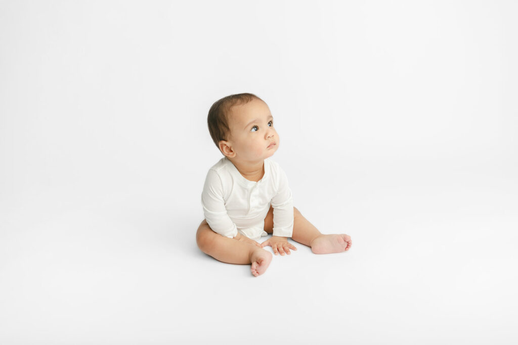 Baby Ezra is photographed for a milestone portrait session in the Looking Up Photography studio, located in Greenwich, Connecticut