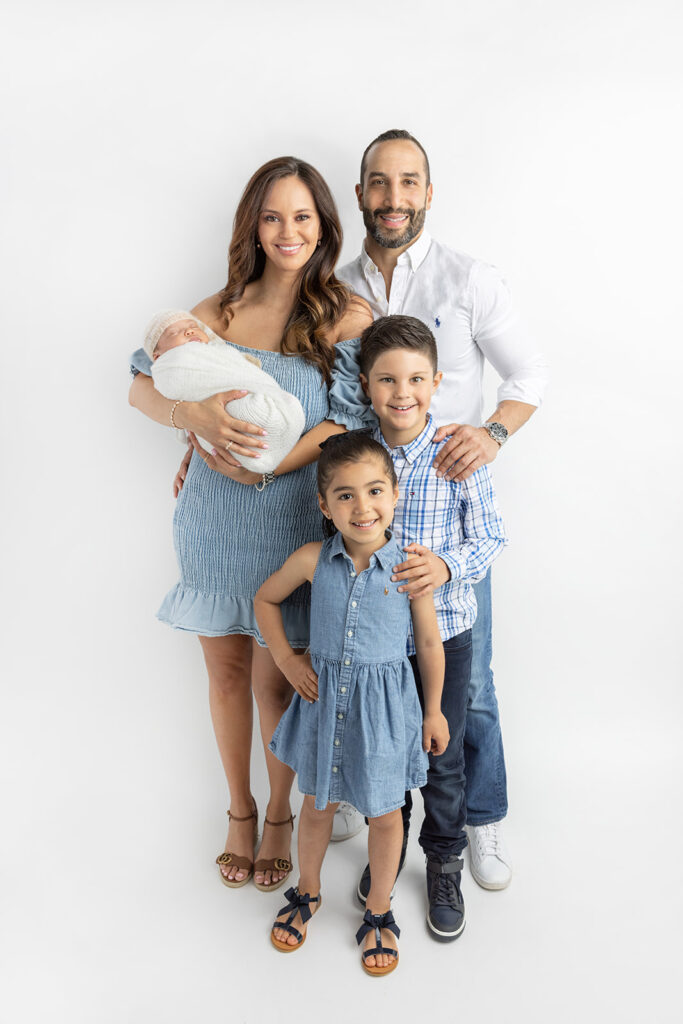 A newly minted family of five is photographed inside the Looking Up Photography studio in Greenwich, Connecticut, by Karen Kahn