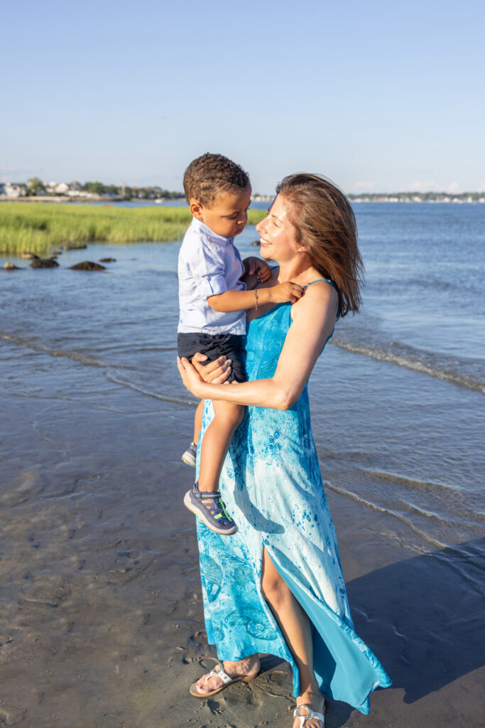 A mom and her two year-old son are photographed in the sunshine along the Connecticut coastline, by Karen Kahn of Looking Up Photography.